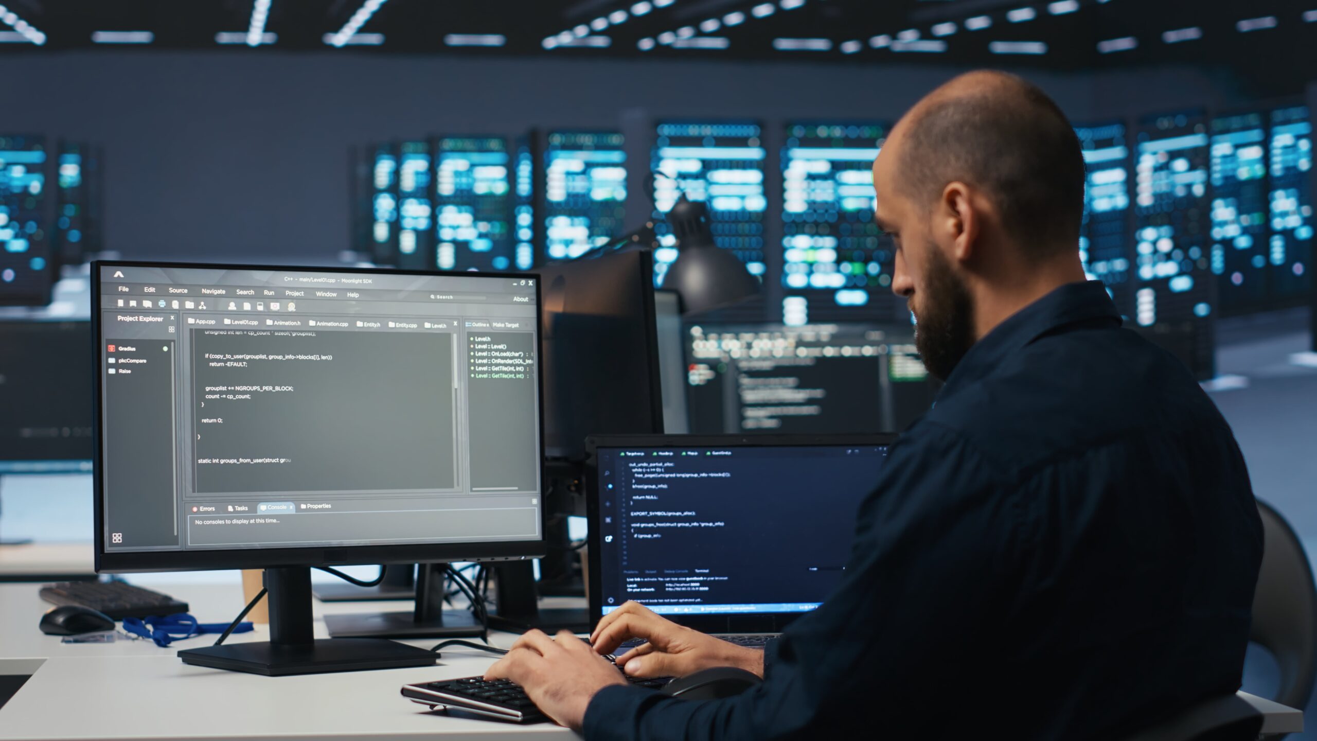 engineers using laptop in computer server room